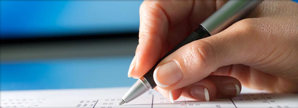 a person’s hand holding a pen
