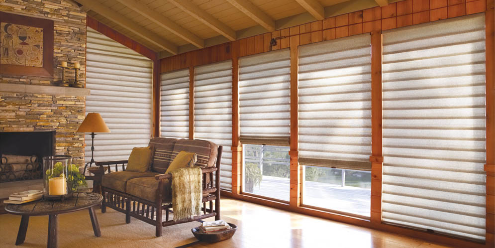 a living room with windows covered with blinds
